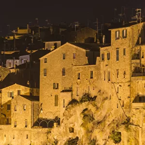 View on the historic part of Pitigliano village at night. Pitigliano, Grosseto province
