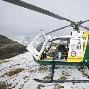 an air ambulance at the site of an injured walker on Silver Howe above Grasmere Lake district UK