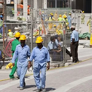 Construction workers working near the Burj Dubai in Dubai