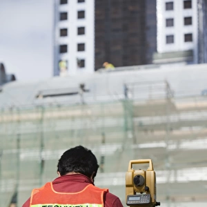 A surveyor working on a construction project in Dubai