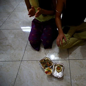 Hare Krishna devotees sit next to their vegetarian food at a temple in Santiago