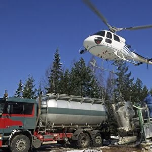 Acid rain, helicopter filling up for lime spreading, to reduce acidity in rivers and wetlands, Sweden