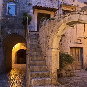 Archway and house in old town at night, Trogir, Dalmatia, Croatia, July