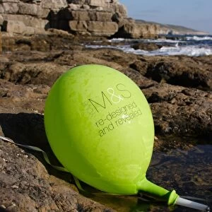 Balloon washed up on rocky shore, Dancing Ledge, Dorset, England, october