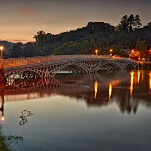 Bridge over river during high tide at dusk, Old Wye Bridge, Chepstow, River Wye, Wye Valley, Monmouthshire, Wales