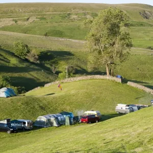 Campsite with campervans and tents on farmland in evening, Swaledale, Yorkshire Dales N. P Campsite with campervans and tents on farmland in evening, Swaledale, Yorkshire Dales N. P