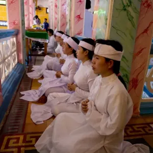Caodaist disciples sitting on balcony during ceremony, Cao Dai temple, Tay Ninh Holy See, Tay Ninh, Tay Ninh Province Caodaist disciples sitting on balcony during ceremony, Cao Dai temple, Tay Ninh Holy See, Tay Ninh, Tay Ninh Province