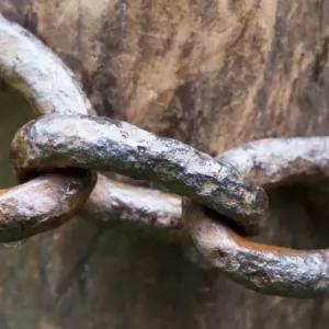 Close-up of old metal chain around gatepost, North Yorkshire, England, July Close-up of old metal chain around gatepost, North Yorkshire, England, July