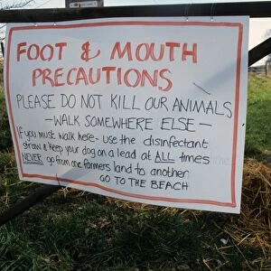 Foot and Mouth Precautions sign on farm gate, with walker using disinfected straw