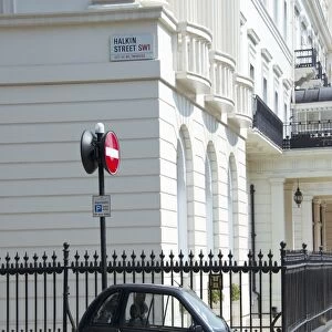 G-Wiz electric car parked on city street, Halkin Street, City of Westminster, London, England, april