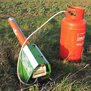Gas-gun, gas powered bird scarer at edge of arable field, Bacton, Suffolk, England, march