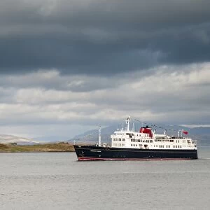 Hebridean Princess cruise ship sailing past island on way into Oban harbour, Kerrera, Inner Hebrides, Argyll, Scotland