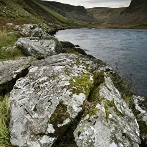 Lichen covered rocks beside lake, Annascaul Lake, Annascaul, Dingle Peninsula, County Kerry, Munster, Ireland, November