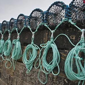 Lobster pots on quayside of harbour, Burnmouth, Scottish Borders, Scotland, july