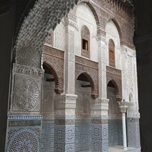 Madrasah courtyard with archway in city, Al-Attarine Madrasa, Fes el Bali, Fes, Morocco, april