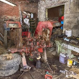 Old International 454 tractor in farm workshop, Sheffield, South Yorkshire, England, March