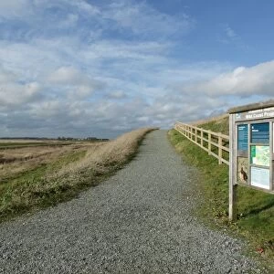 Reserve entrance sign and path in estuary marshland, reclaimed saltmarsh in managed retreat scheme