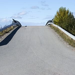 Road over humpback bridge, Sweden, september