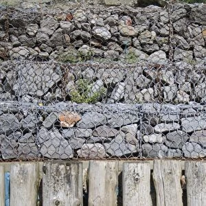 Rock filled gabions used as coastal erosion defence at base of sea cliffs, Whitecliff Bay, Isle of Wight, England, june