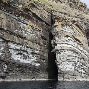 Sea cliff and arch rock formation, Giants Fingers Bressay, Shetland Islands, Scotland, June