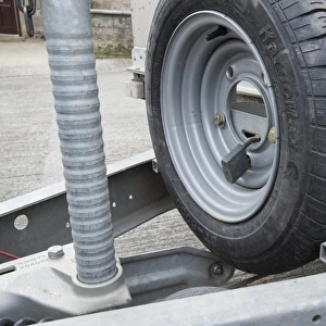 Spare wheel lock on farm trailer in farmyard, Lancashire, England, August