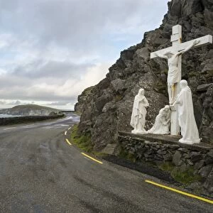 Statue with Jesus on Crucifix with Mary and Saint John, beside coastal road, Coumeenole South, Slea Head