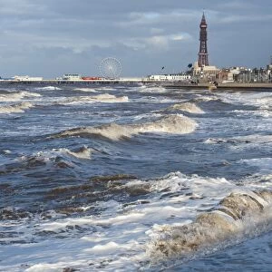 Stormy sea at high tide in seaside resort town, Blackpool Tower in background, Blackpool, Lancashire, England, january