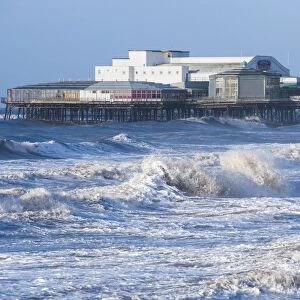 Stormy sea and Victorian pier in seaside resort town, North Pier, Blackpool, Lancashire, England, January