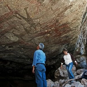 Tourists looking at San Borjitas cave paintings, oldest cave paintings in western hemisphere, circa 7500 years old