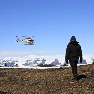 Tourists waiting for arrival of helicopter, Devil Island, Weddell Sea, Antarctica, December