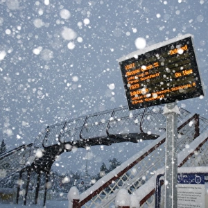 Train delayed sign at railway station during snowstorm, Aviemore Station, Cairngorms N. P. Grampian Mountains, Scotland, january