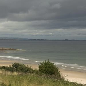 View of beach and coastline with stormy sky, Bamburgh, Northumberland, England, august