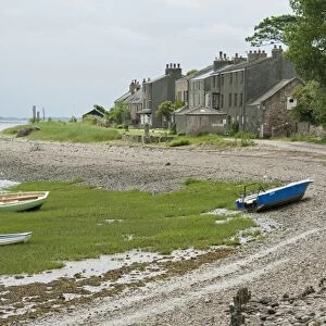 View of boats on shoreline and houses of coastal village, only community on U. K