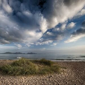 View of clouds over coastline and sand dunes, Newborough, Anglesey, Wales, August