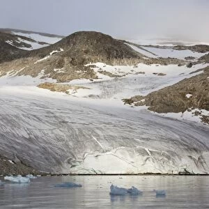 View of coastal glacier terminus and mountains, Raudfjorden, Spitsbergen, Svalbard, August
