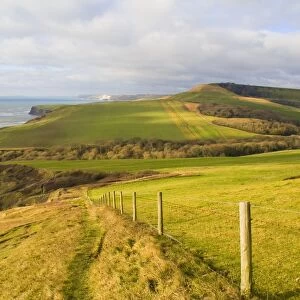 View of coastline with farmland and rough sea from high cliff, near Chapmans Pool, Dorset, England, january
