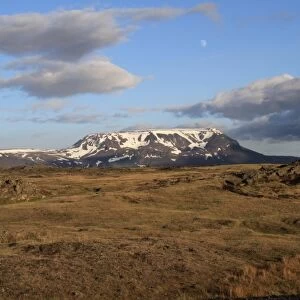 View of distant mountain in evening sunlight, with waxing moon, Blafjall, Myvatn, Iceland, June