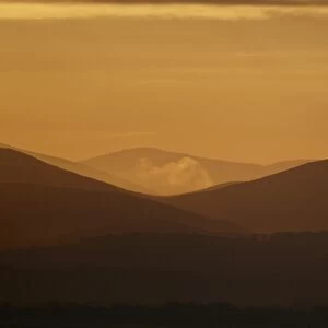 View across estuary towards distant hills at sunrise, looking towards Lake District (Cumbria, England), Solway Firth