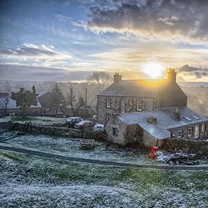 View of farmhouse in frost at sunrise, Church Brough, Kirkby Stephen, Cumbria, England, December