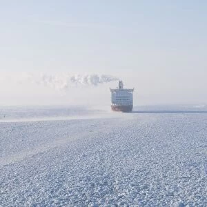 View of ferry in frozen sea at dawn, near Helsinki, Uusimaa, Gulf of Finland, Baltic Sea, Finland, winter