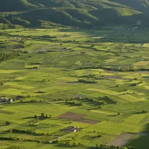 View of field patterns in mountain valley, in evening sunlight, Valle di Frascaro, near Norcia, Apennines, Italy, May View of field patterns in mountain valley, in evening sunlight, Valle di Frascaro, near Norcia, Apennines, Italy, May