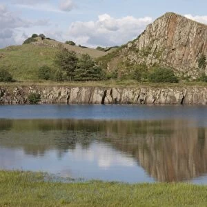 View of flooded former whinstone quarry with exposed rockface, Cawfields Quarry, Hadrians Wall, Northumberland N. P
