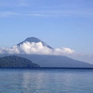 View of forest covered volcano cone on shores of coastal bay, Kimbe Bay, West New Britain Province, New Britain