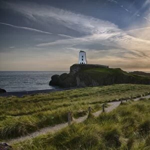View of lighthouse and coastline on tidal island, Llanddwyn Island, Newborough Warren National Nature Reserve