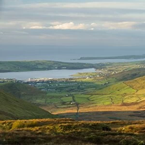 View over moorland towards coastal farmland and village, Dingle Peninsula, County Kerry, Munster, Ireland, November