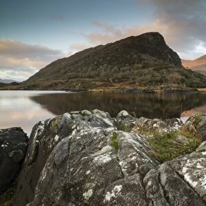 View of mountain reflected in narrow channel connecting lakes at sunrise, The Long Range, Lakes of Killarney