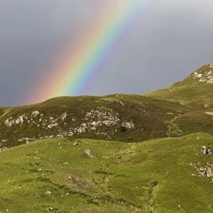 View of rainbow over mountains, near Dornie, Ross and Cromarty, Highlands, Scotland, July