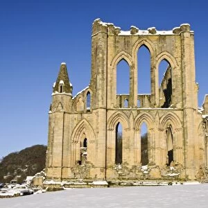 View of ruined cistercian abbey in snow, Rievaulx Abbey, North York Moors N. P. North Yorkshire, England, January
