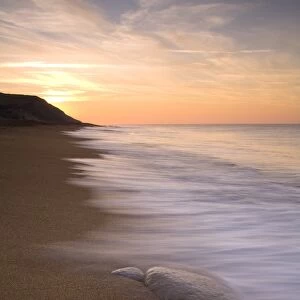 View of sandy beach at sunrise, Burton Bradstock, Dorset, England, february