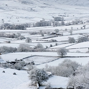 View over snow covered farmland, Howgills, Ravenstonedale, Cumbria, England, December